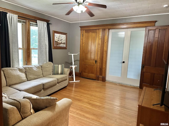 653 Ferry Rd, Miles, IA 52064 - living area with a ceiling fan, light wood-style flooring, and crown molding
