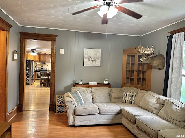 653 Ferry Rd, Miles, IA 52064 - living room with ceiling fan, ornamental molding, light wood-type flooring, and plenty of natural light