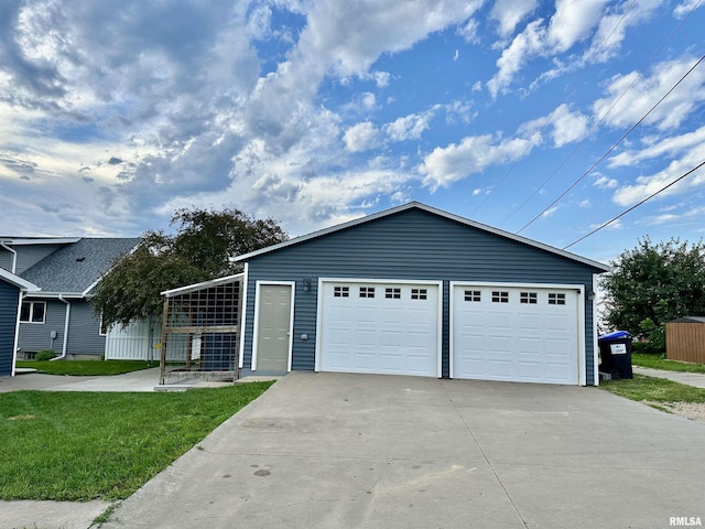 653 Ferry Rd, Miles, IA 52064 - view of front facade featuring a garage, an outbuilding, and a front lawn