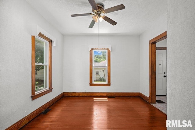204 15th Ave, East Moline, IL 61244 - unfurnished room featuring hardwood / wood-style floors, a textured ceiling, and a ceiling fan