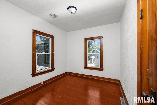 204 15th Ave, East Moline, IL 61244 - unfurnished room featuring dark wood-style floors and baseboards