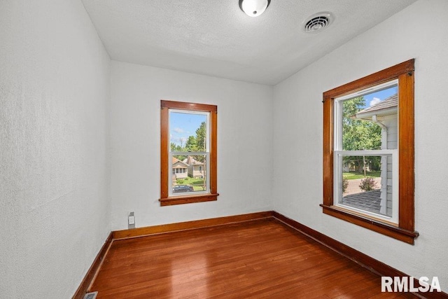 204 15th Ave, East Moline, IL 61244 - empty room featuring wood finished floors and baseboards