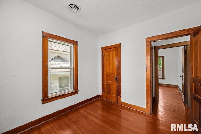 204 15th Ave, East Moline, IL 61244 - unfurnished room featuring baseboards and dark wood-type flooring