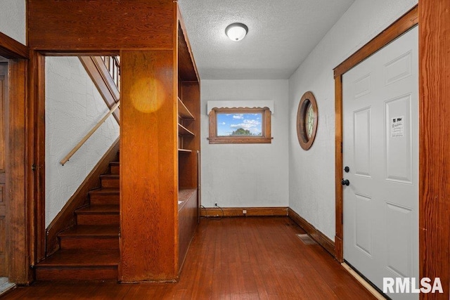 204 15th Ave, East Moline, IL 61244 - entrance foyer featuring dark wood-style flooring, a textured ceiling, and stairway