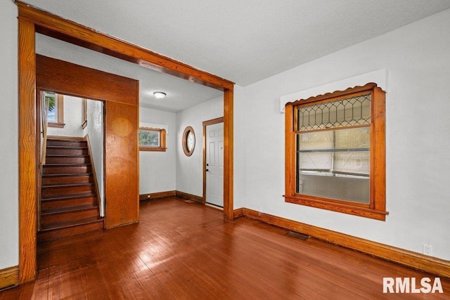 204 15th Ave, East Moline, IL 61244 - unfurnished room featuring dark wood-style flooring and stairway