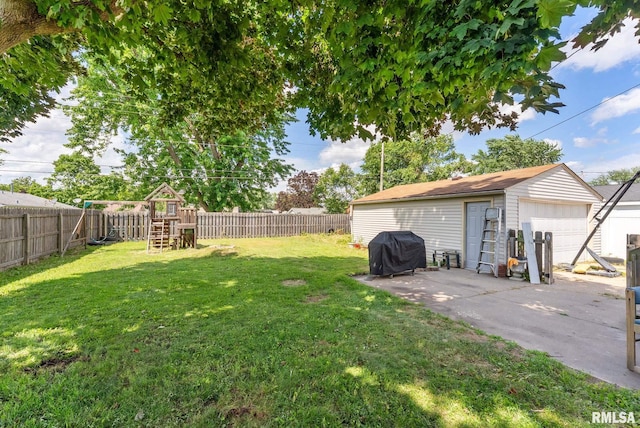531 32nd Ave, East Moline, IL 61244 - fenced backyard featuring a playground, a detached garage, and an outdoor structure