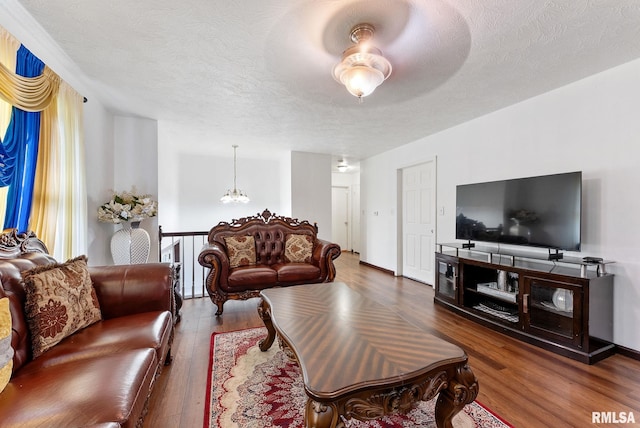531 32nd Ave, East Moline, IL 61244 - living room featuring wood finished floors, a textured ceiling, and a chandelier