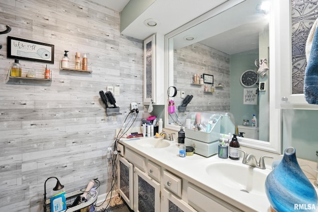 3295 Johnathan Ave, Bettendorf, IA 52722 - bathroom featuring wooden walls and double vanity