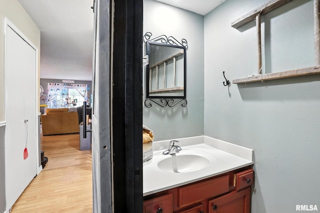 3295 Johnathan Ave, Bettendorf, IA 52722 - bathroom featuring wood finished floors and vanity