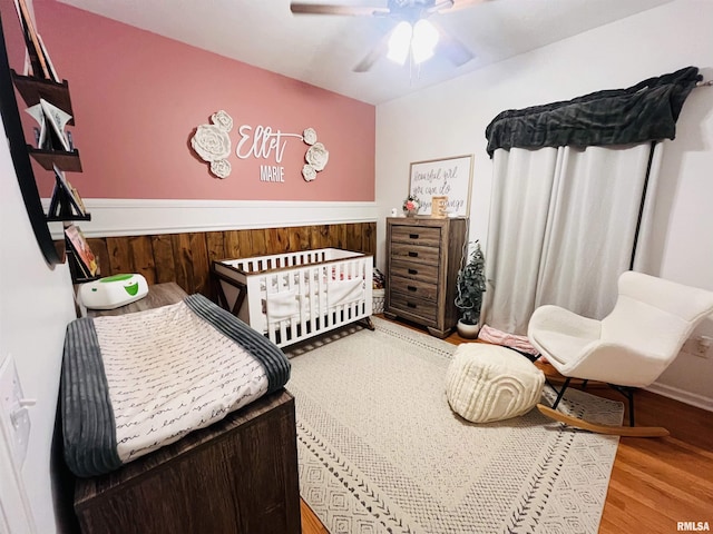 66 Windy Hill Dr, Murphysboro, IL 62966 - bedroom with wood finished floors, a nursery area, and a ceiling fan