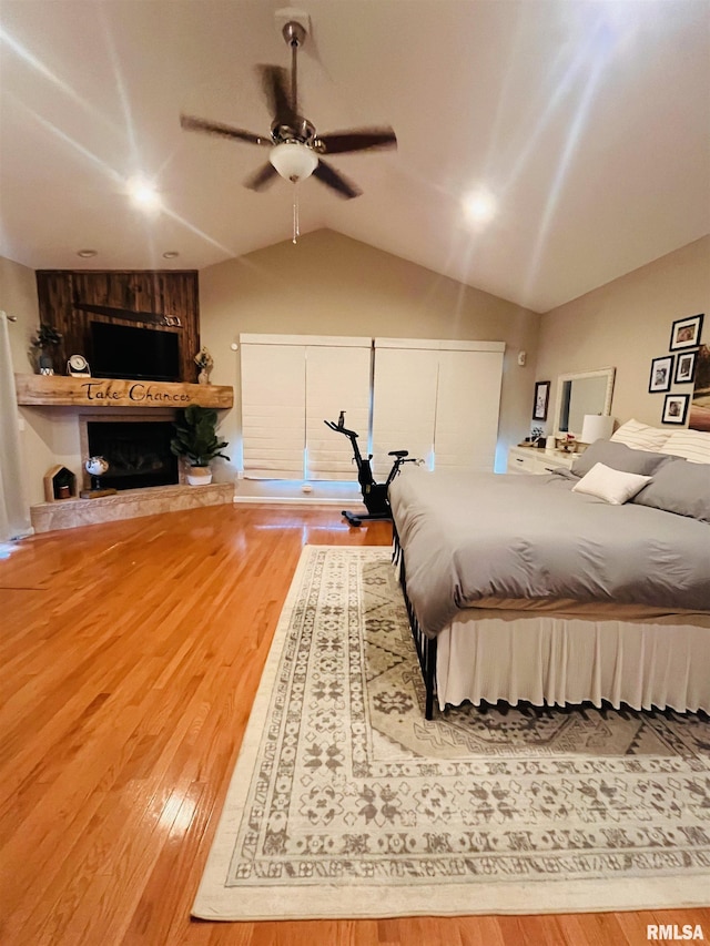 66 Windy Hill Dr, Murphysboro, IL 62966 - bedroom featuring wood finished floors, lofted ceiling, a fireplace, and ceiling fan