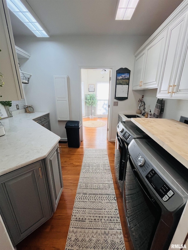 66 Windy Hill Dr, Murphysboro, IL 62966 - kitchen featuring separate washer and dryer, dark wood-style flooring, and white cabinetry