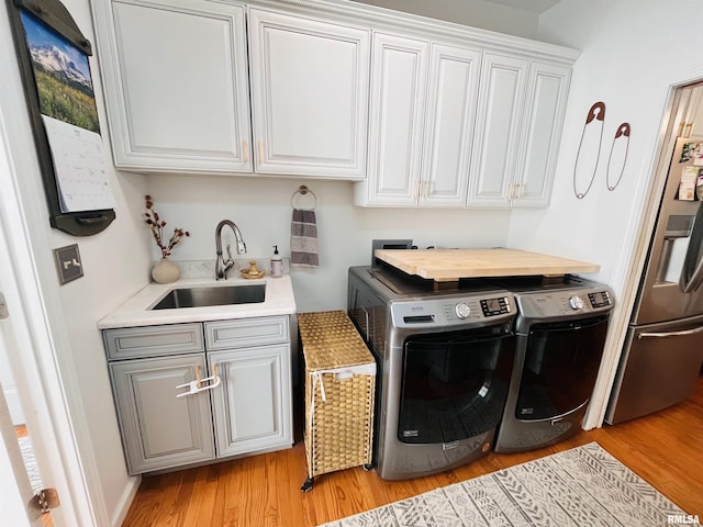 66 Windy Hill Dr, Murphysboro, IL 62966 - washroom with cabinet space, washer and clothes dryer, and light wood-style floors