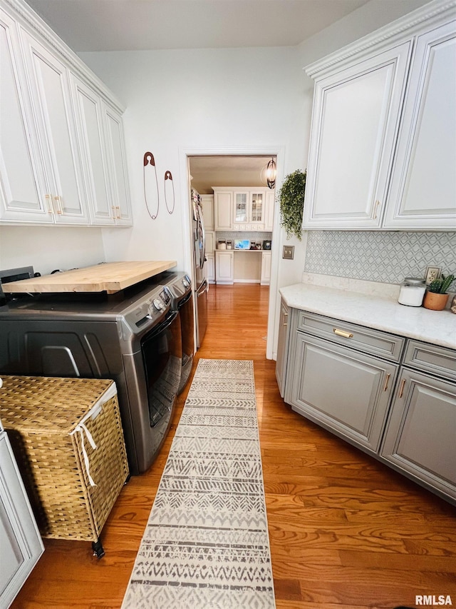 66 Windy Hill Dr, Murphysboro, IL 62966 - laundry room with cabinet space, separate washer and dryer, and wood finished floors