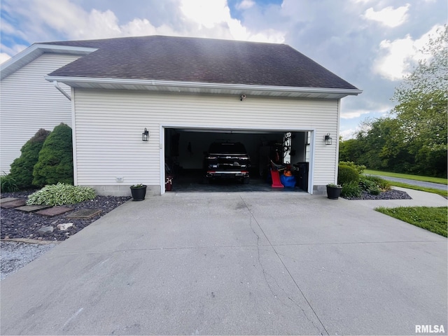 66 Windy Hill Dr, Murphysboro, IL 62966 - view of side of property with driveway, a shingled roof, and a garage