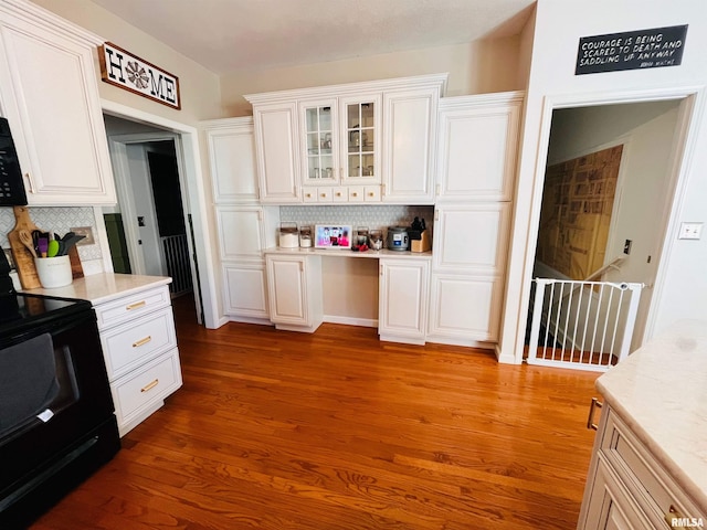 66 Windy Hill Dr, Murphysboro, IL 62966 - kitchen with black electric range oven, backsplash, white cabinetry, and light countertops