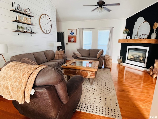 66 Windy Hill Dr, Murphysboro, IL 62966 - living room featuring ceiling fan, wood finished floors, crown molding, a glass covered fireplace, and wooden walls