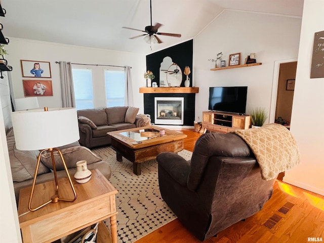66 Windy Hill Dr, Murphysboro, IL 62966 - living room featuring ceiling fan, light wood-type flooring, a glass covered fireplace, lofted ceiling, and ornamental molding
