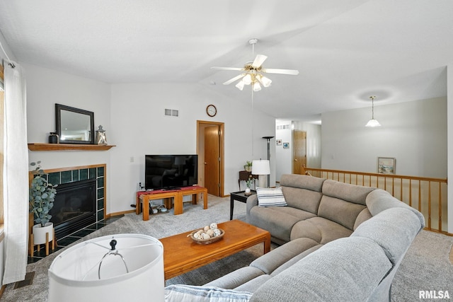 2722 Linwood Ct, Davenport, IA 52806 - carpeted living room featuring ceiling fan, vaulted ceiling, and a tile fireplace