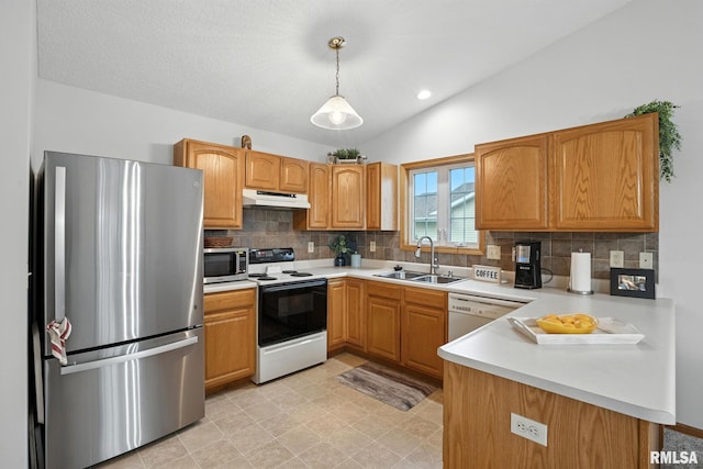 2722 Linwood Ct, Davenport, IA 52806 - kitchen with appliances with stainless steel finishes, under cabinet range hood, tasteful backsplash, a peninsula, and lofted ceiling