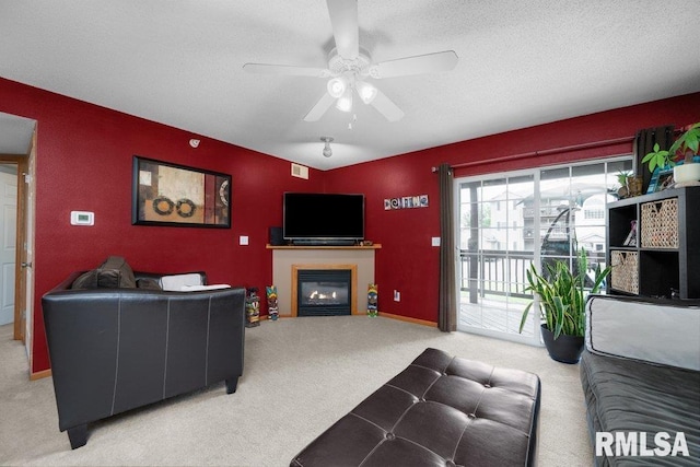 3209 S 16th Ave Unit 203, Eldridge, IA 52748 - carpeted living room with ceiling fan, a glass covered fireplace, and a textured ceiling