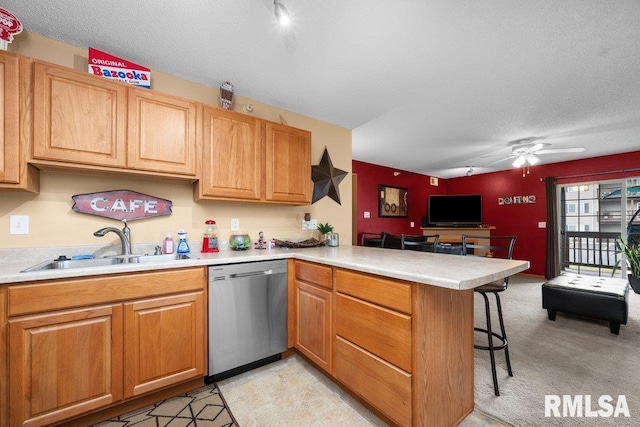 3209 S 16th Ave Unit 203, Eldridge, IA 52748 - kitchen featuring dishwasher, a peninsula, a kitchen bar, light countertops, and ceiling fan