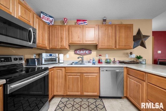3209 S 16th Ave Unit 203, Eldridge, IA 52748 - kitchen with appliances with stainless steel finishes, light countertops, and a textured ceiling