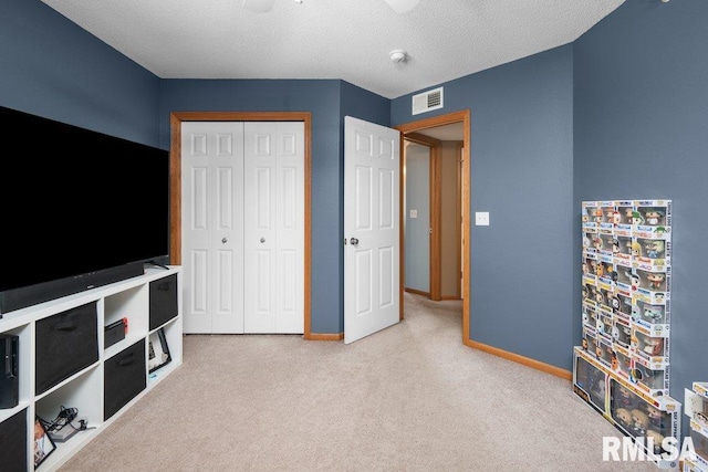 3209 S 16th Ave Unit 203, Eldridge, IA 52748 - unfurnished bedroom with carpet flooring, a closet, and a textured ceiling