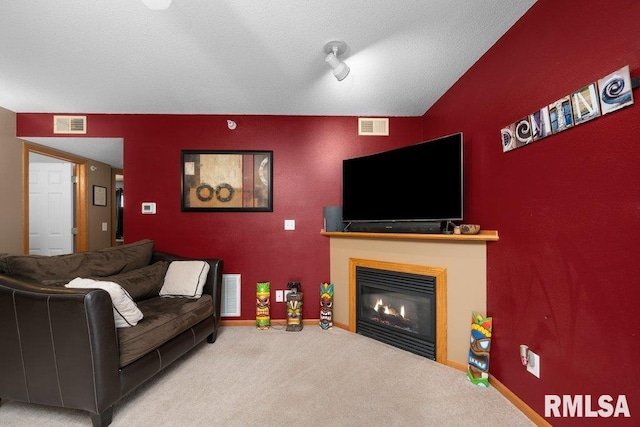 3209 S 16th Ave Unit 203, Eldridge, IA 52748 - living room featuring a glass covered fireplace, carpet floors, and a textured ceiling