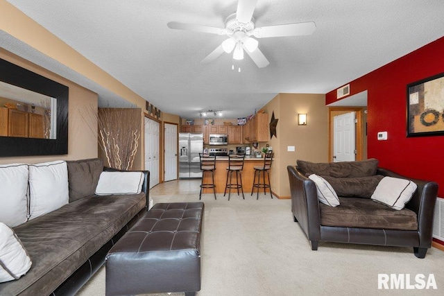 3209 S 16th Ave Unit 203, Eldridge, IA 52748 - living area featuring a ceiling fan and light carpet