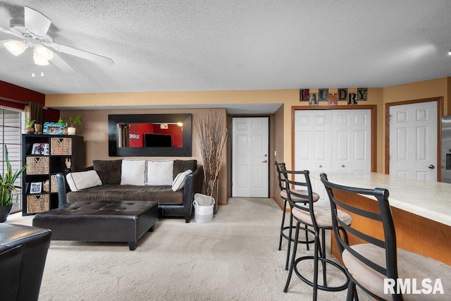 3209 S 16th Ave Unit 203, Eldridge, IA 52748 - living room with light colored carpet, ceiling fan, and a textured ceiling