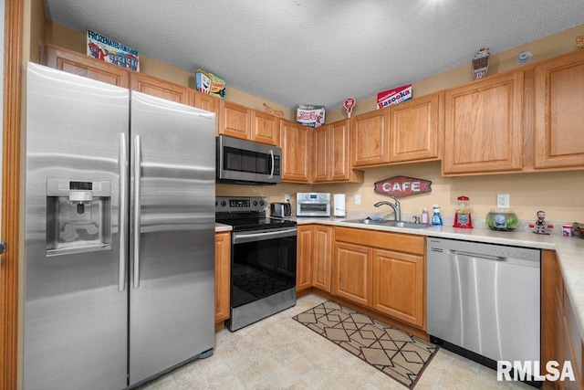 3209 S 16th Ave Unit 203, Eldridge, IA 52748 - kitchen with stainless steel appliances, light countertops, and a textured ceiling