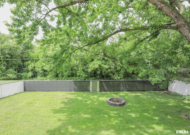 5022 Northbrook Ct, Davenport, IA 52806 - fenced backyard featuring a fire pit