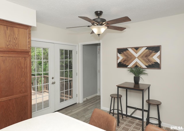 5022 Northbrook Ct, Davenport, IA 52806 - bedroom with french doors, access to outside, wood finished floors, a textured ceiling, and a ceiling fan