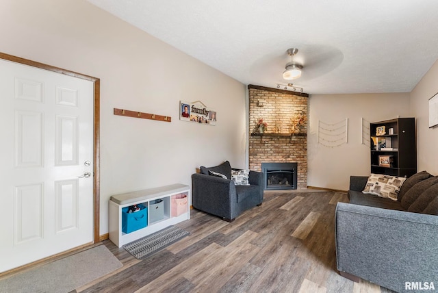 303 S Park View Dr, Park View, IA 52748 - living room featuring wood finished floors and a fireplace