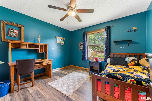303 S Park View Dr, Park View, IA 52748 - bedroom with wood finished floors, a textured ceiling, and ceiling fan