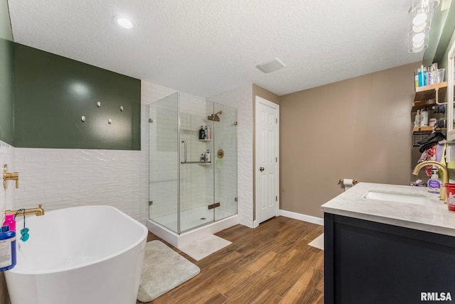 303 S Park View Dr, Park View, IA 52748 - bathroom with a shower stall, a freestanding bath, wood finished floors, tile walls, and double vanity