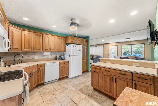 303 S Park View Dr, Park View, IA 52748 - kitchen featuring white appliances, light countertops, recessed lighting, and brown cabinets