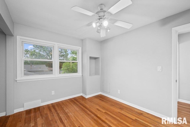 1815 Lincoln Rd, Bettendorf, IA 52722 - empty room with wood finished floors and a ceiling fan