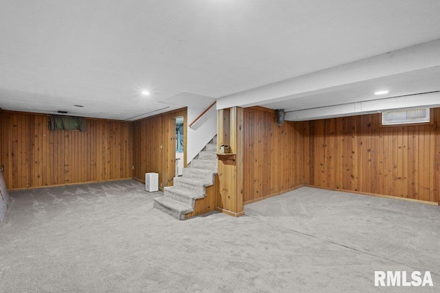 1815 Lincoln Rd, Bettendorf, IA 52722 - below grade area featuring carpet, wood walls, and stairway