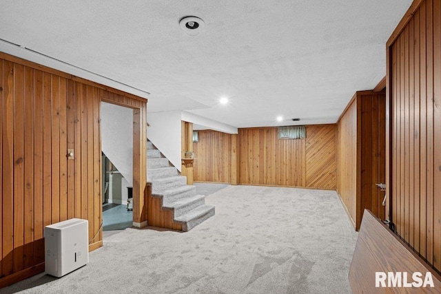 1815 Lincoln Rd, Bettendorf, IA 52722 - finished below grade area with wood walls, carpet flooring, stairway, and a textured ceiling