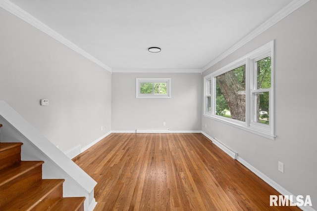 1815 Lincoln Rd, Bettendorf, IA 52722 - empty room with wood finished floors, stairs, and ornamental molding