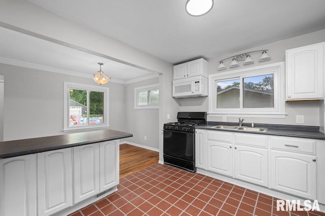 1815 Lincoln Rd, Bettendorf, IA 52722 - kitchen with black range with gas cooktop, white microwave, dark countertops, white cabinetry, and crown molding