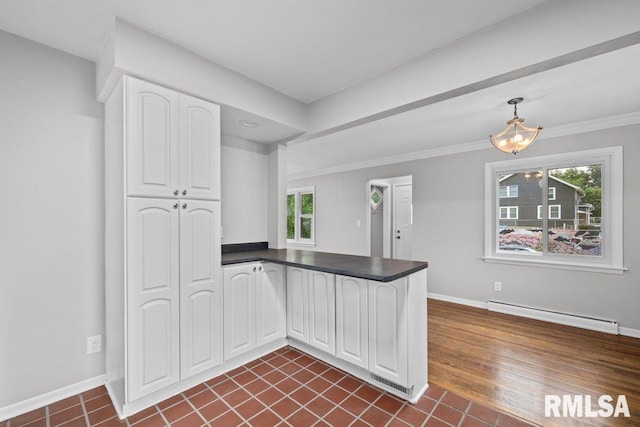 1815 Lincoln Rd, Bettendorf, IA 52722 - kitchen with a baseboard heating unit, a peninsula, dark countertops, white cabinets, and ornamental molding