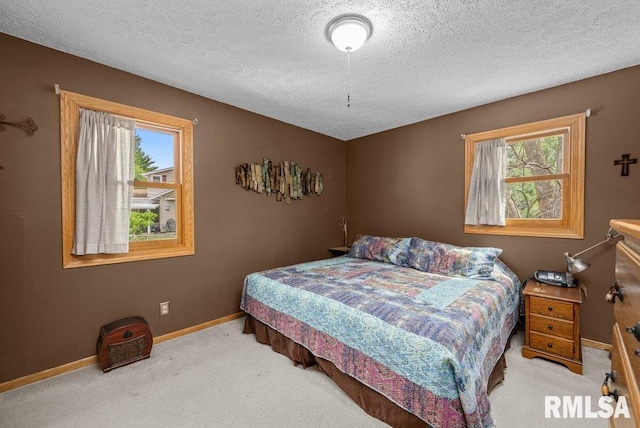 2401 W Dale Ct, Bettendorf, IA 52722 - bedroom with a textured ceiling and carpet