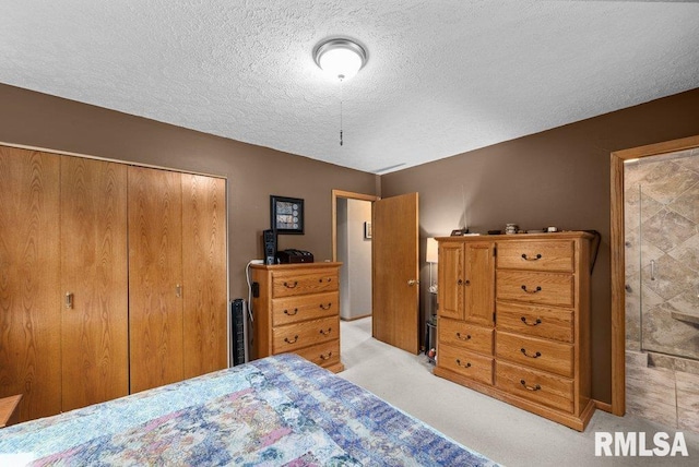 2401 W Dale Ct, Bettendorf, IA 52722 - bedroom with a closet, light colored carpet, and a textured ceiling