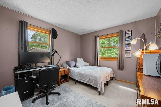 2401 W Dale Ct, Bettendorf, IA 52722 - bedroom featuring multiple windows, carpet, a textured ceiling, and an office area