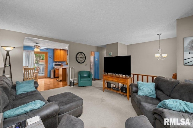 2401 W Dale Ct, Bettendorf, IA 52722 - living area with a chandelier, a textured ceiling, a ceiling fan, and light carpet
