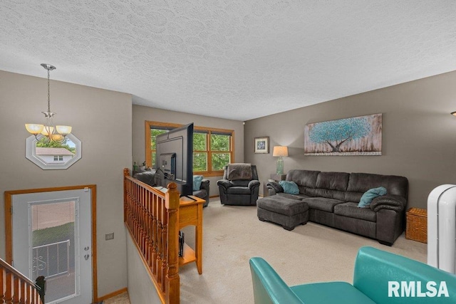 2401 W Dale Ct, Bettendorf, IA 52722 - carpeted living area featuring a chandelier and a textured ceiling