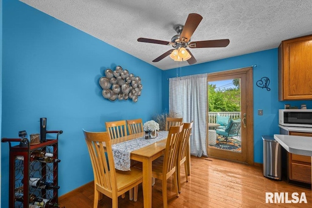 2401 W Dale Ct, Bettendorf, IA 52722 - dining space featuring a textured ceiling, light wood finished floors, and a ceiling fan